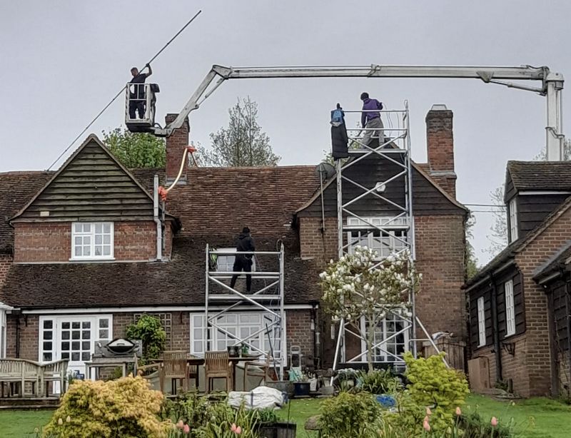 The Roof Moss Cleaners using cherry picker and scaffolding to clean roof safely and professionally in Ascot, Berkshire